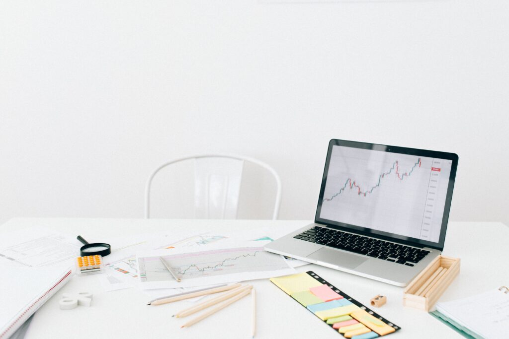 White table with laptop showing financial graph