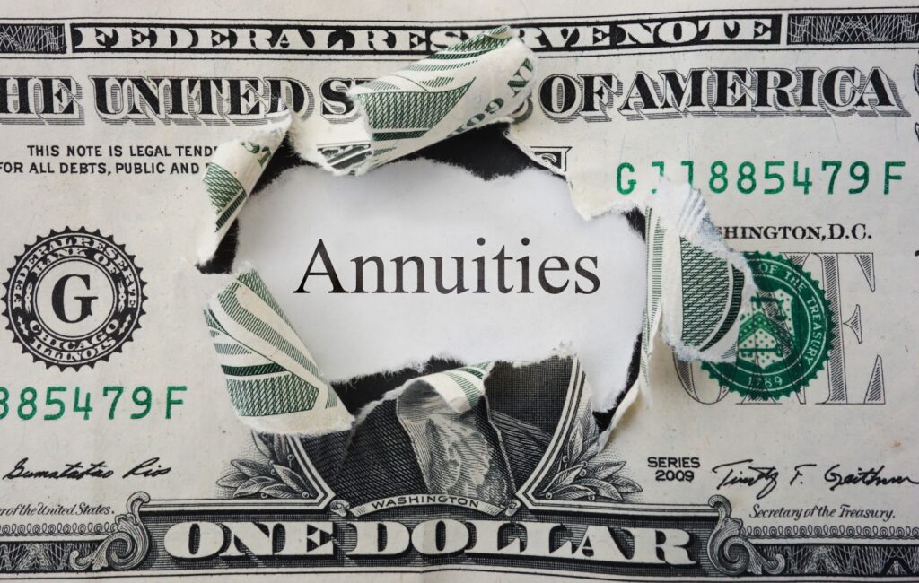 hold in dollar bill with "annuities" text behind it