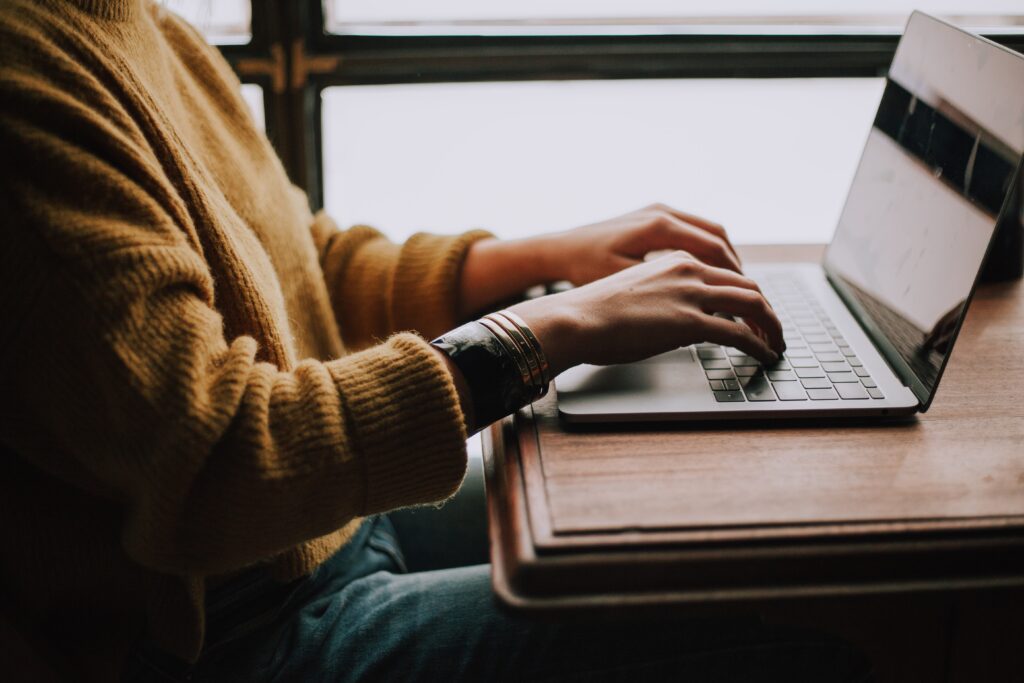 Young woman typing on laptop